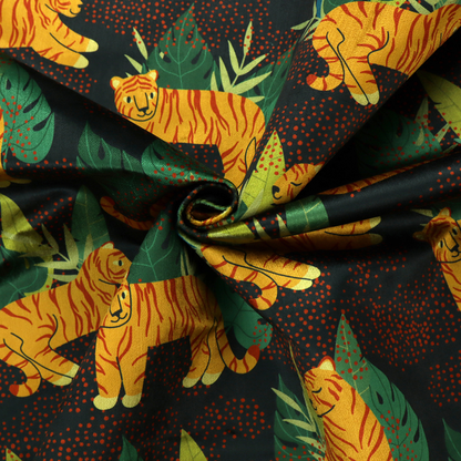 A vibrant fabric pattern featuring illustrated orange tigers in various poses surrounded by dark green tropical leaves and foliage against a dark background with red dotted accents.   