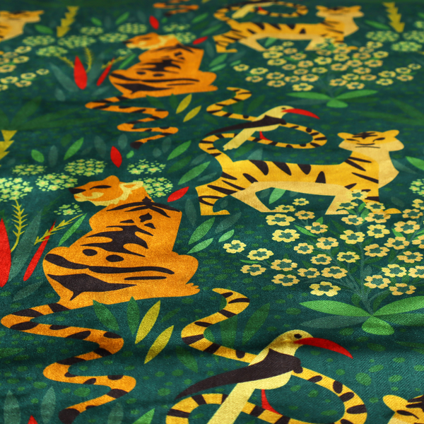 A detailed tropical jungle pattern fabric featuring illustrated yellow and black tigers, birds with red beaks, palm trees, and small white flowers on a deep green background.   