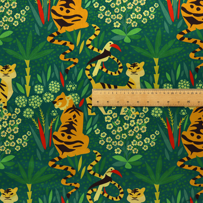 A detailed tropical jungle pattern fabric featuring illustrated yellow and black tigers, birds with red beaks, palm trees, and small white flowers on a deep green background.   