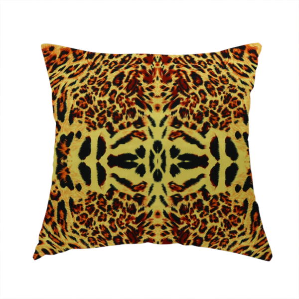 The fabric used to create this handmade cushion is a bold, symmetrical leopard print fabric featuring a repeating kaleidoscope pattern of black and golden-brown rosettes on a warm yellow-gold background.