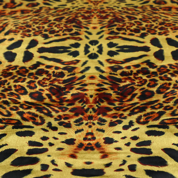A bold, symmetrical leopard print fabric featuring a repeating kaleidoscope pattern of black and golden-brown rosettes on a warm yellow-gold background.