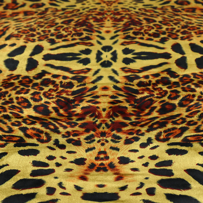 A bold, symmetrical leopard print fabric featuring a repeating kaleidoscope pattern of black and golden-brown rosettes on a warm yellow-gold background.