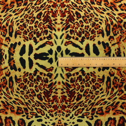 A bold, symmetrical leopard print fabric featuring a repeating kaleidoscope pattern of black and golden-brown rosettes on a warm yellow-gold background.