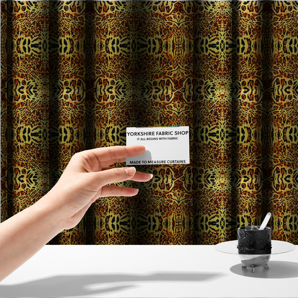 The fabric used to create these made-to-measure curtains is a bold, symmetrical leopard print fabric featuring a repeating kaleidoscope pattern of black and golden-brown rosettes on a warm yellow-gold background.