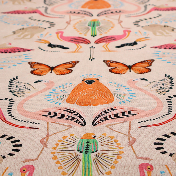 A whimsical tropical jungle patterned fabric featuring pink flamingos, orange orangutans, monarch butterflies, lemurs with striped tails, and vibrant birds on a light beige background.   