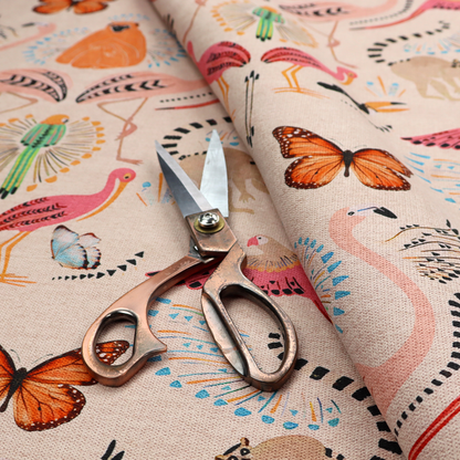 A whimsical tropical jungle patterned fabric featuring pink flamingos, orange orangutans, monarch butterflies, lemurs with striped tails, and vibrant birds on a light beige background.   