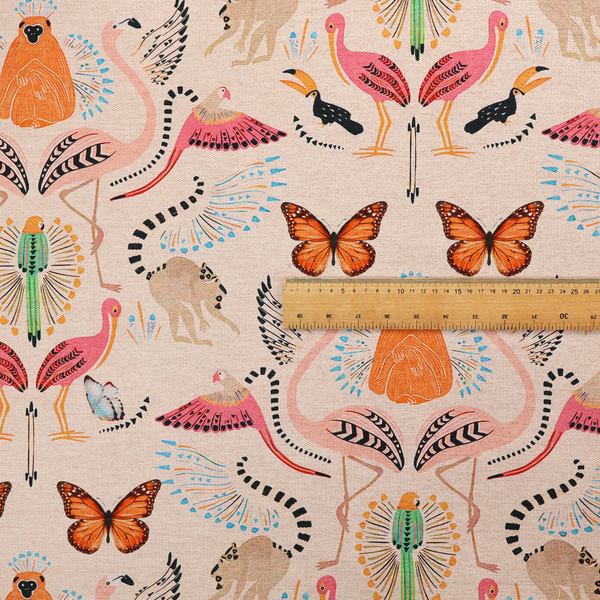 A whimsical tropical jungle patterned fabric featuring pink flamingos, orange orangutans, monarch butterflies, lemurs with striped tails, and vibrant birds on a light beige background.   