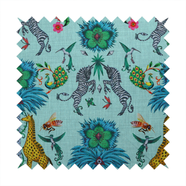An enchanting turquoise-toned fabric pattern featuring zebras, giraffes, hummingbirds, peacocks, bees, and mystical blue flowers with eye motifs on a light aqua background.