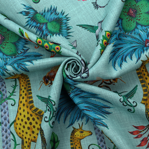 An enchanting turquoise-toned fabric pattern featuring zebras, giraffes, hummingbirds, peacocks, bees, and mystical blue flowers with eye motifs on a light aqua background.