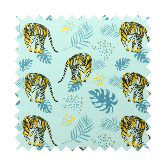 A tropical jungle upholstery fabric on a light mint-blue background featuring a repeating pattern of yellow and black tigers surrounded by teal monstera leaves, palm fronds, and yellow dot clusters.   