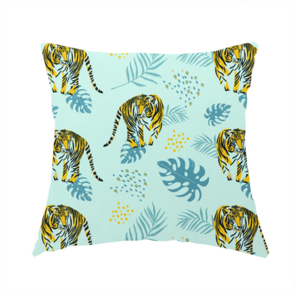 The fabric used to create this handmade cushion is a tropical jungle upholstery fabric on a light mint-blue background featuring a repeating pattern of yellow and black tigers surrounded by teal monstera leaves, palm fronds, and yellow dot clusters.   