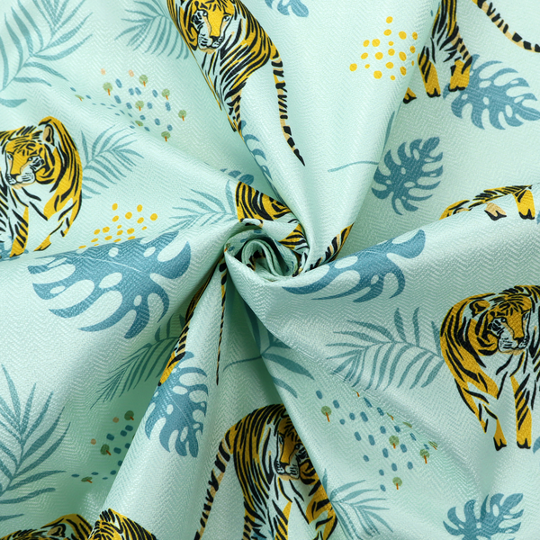 A tropical jungle upholstery fabric on a light mint-blue background featuring a repeating pattern of yellow and black tigers surrounded by teal monstera leaves, palm fronds, and yellow dot clusters.   