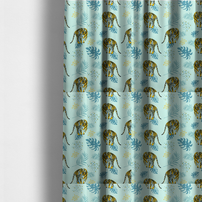 The fabric used to create these made-to-measure curtains is a tropical jungle upholstery fabric on a light mint-blue background featuring a repeating pattern of yellow and black tigers surrounded by teal monstera leaves, palm fronds, and yellow dot clusters.   