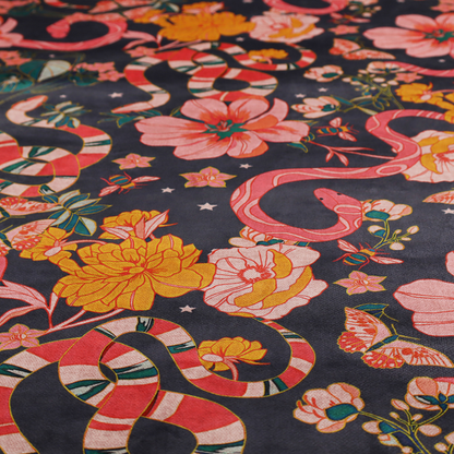 A rich, dark botanical fabric pattern featuring intertwined pink and red snakes, large pink and yellow flowers, and delicate butterflies against a dark navy background.