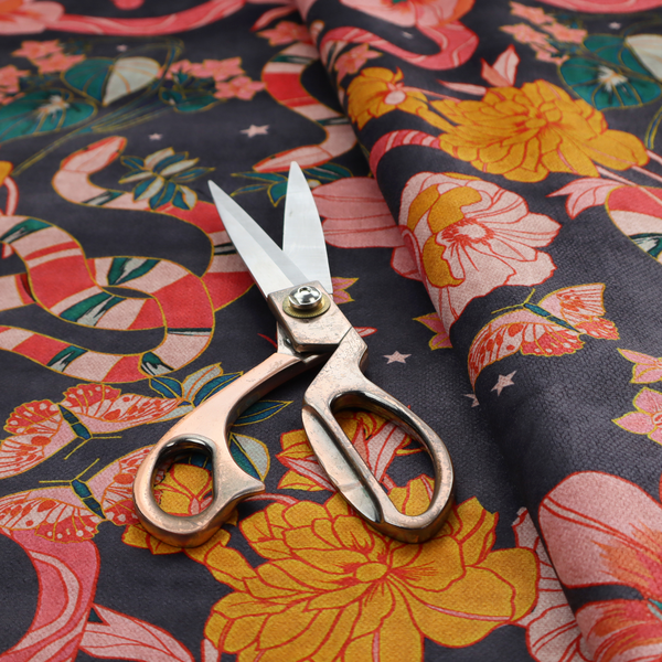 A rich, dark botanical fabric pattern featuring intertwined pink and red snakes, large pink and yellow flowers, and delicate butterflies against a dark navy background.