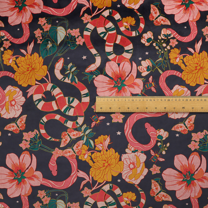 A rich, dark botanical fabric pattern featuring intertwined pink and red snakes, large pink and yellow flowers, and delicate butterflies against a dark navy background.