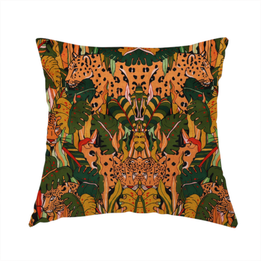 The fabric used to create this handmade cushion is a intricate, symmetrical jungle pattern fabric featuring spotted leopards and lush green tropical foliage in warm autumn tones of orange, gold, and deep green.