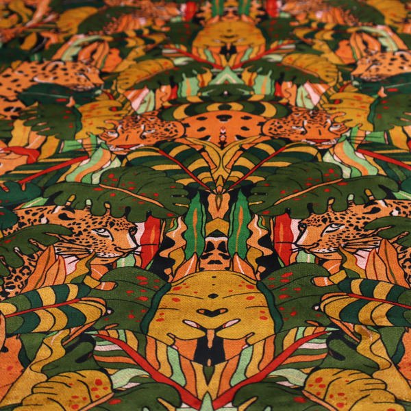 An intricate, symmetrical jungle pattern fabric featuring spotted leopards and lush green tropical foliage in warm autumn tones of orange, gold, and deep green.
