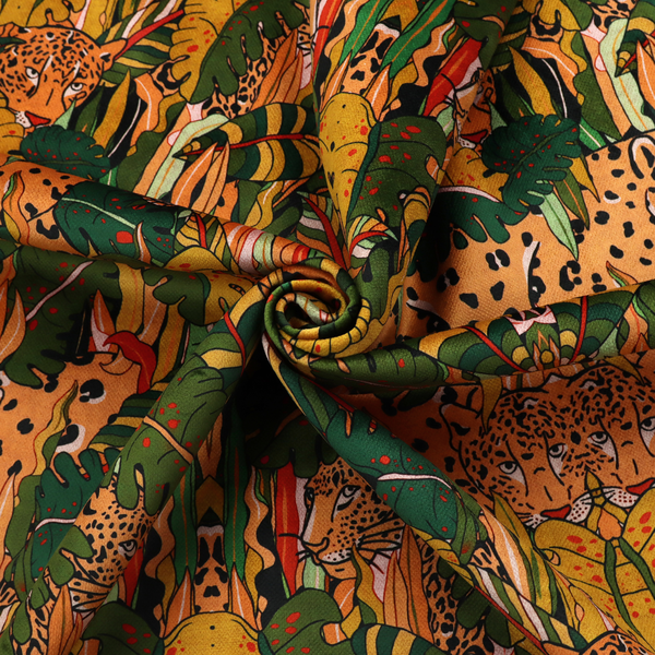 An intricate, symmetrical jungle pattern fabric featuring spotted leopards and lush green tropical foliage in warm autumn tones of orange, gold, and deep green.