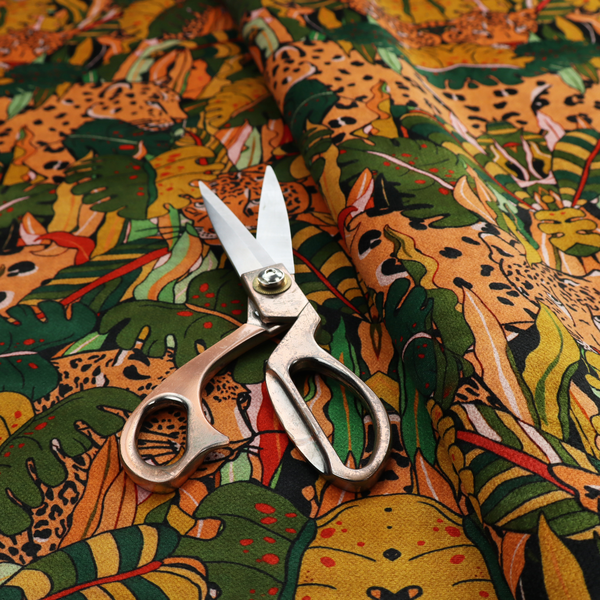 An intricate, symmetrical jungle pattern fabric featuring spotted leopards and lush green tropical foliage in warm autumn tones of orange, gold, and deep green.