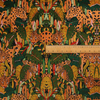 An intricate, symmetrical jungle pattern fabric featuring spotted leopards and lush green tropical foliage in warm autumn tones of orange, gold, and deep green.