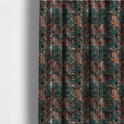 The fabric used to create these made-to-measure curtains is a moody teal fabric pattern featuring seated leopards, a toucan, and a white cockatoo amidst autumn-toned tropical leaves and foliage.
