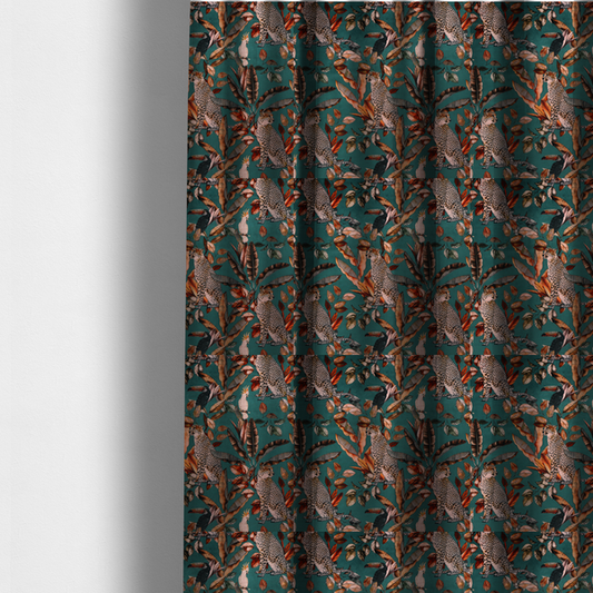 The fabric used to create these made-to-measure curtains is a moody teal fabric pattern featuring seated leopards, a toucan, and a white cockatoo amidst autumn-toned tropical leaves and foliage.