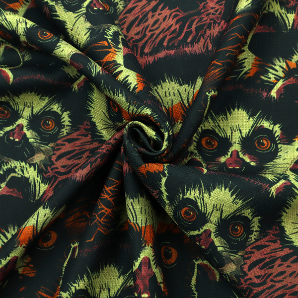 Fabric pattern featuring a repeating, illustrated design of lemur faces in lime green, orange, and dark brown.   