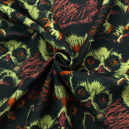 Fabric pattern featuring a repeating, illustrated design of lemur faces in lime green, orange, and dark brown.   