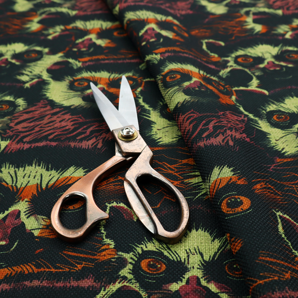 Fabric pattern featuring a repeating, illustrated design of lemur faces in lime green, orange, and dark brown.   