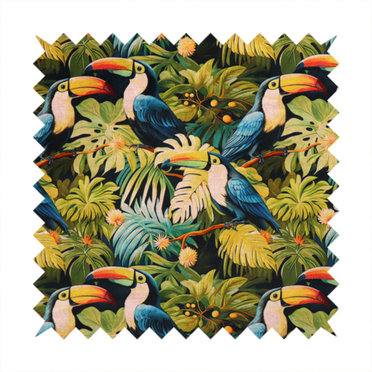 Tropical fabric featuring a repeating pattern of blue toucans perched among lush monstera leaves, palm fronds, and yellow flowers.   