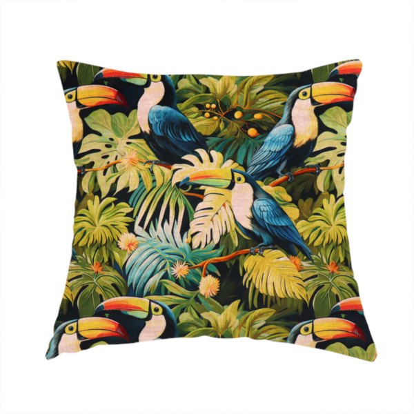 The fabric used to create this handmade cushion is a tropical fabric featuring a repeating pattern of blue toucans perched among lush monstera leaves, palm fronds, and yellow flowers.   