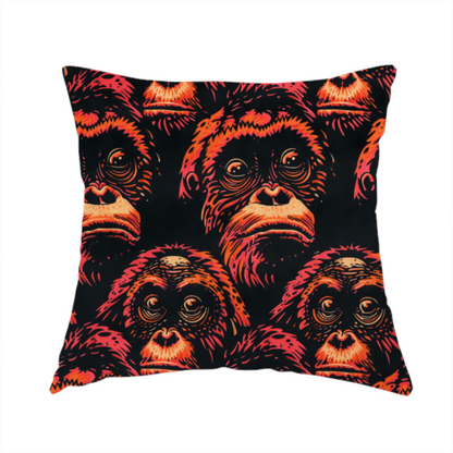 The fabric used to create this handmade cushion is a fabric pattern featuring a repeating graphic illustration of orangutan faces in orange, peach, and reddish-pink tones against a dark black background.   