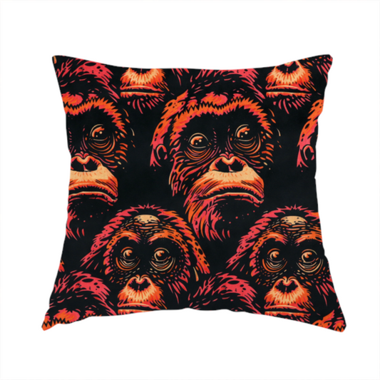 The fabric used to create this handmade cushion is a fabric pattern featuring a repeating graphic illustration of orangutan faces in orange, peach, and reddish-pink tones against a dark black background.   