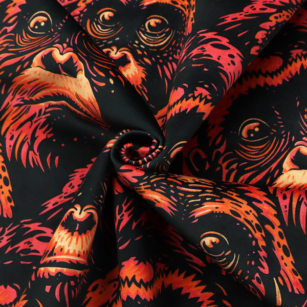 Fabric pattern featuring a repeating graphic illustration of orangutan faces in orange, peach, and reddish-pink tones against a dark black background.   