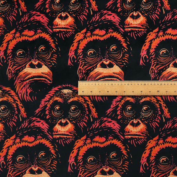 Fabric pattern featuring a repeating graphic illustration of orangutan faces in orange, peach, and reddish-pink tones against a dark black background.   