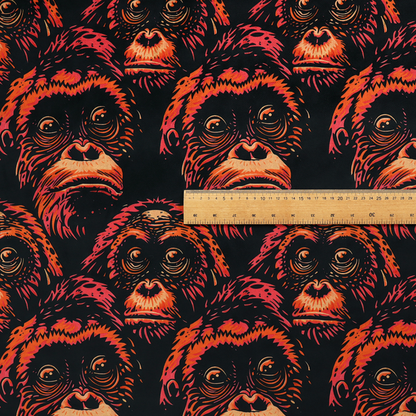 Fabric pattern featuring a repeating graphic illustration of orangutan faces in orange, peach, and reddish-pink tones against a dark black background.   