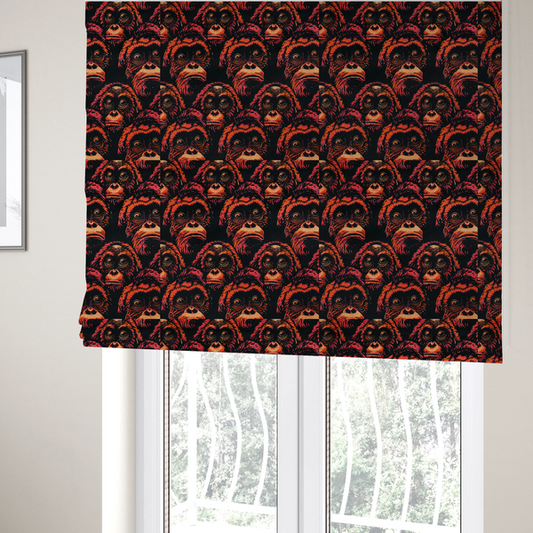 The fabric used to create these Roman blinds is a fabric pattern featuring a repeating graphic illustration of orangutan faces in orange, peach, and reddish-pink tones against a dark black background.   