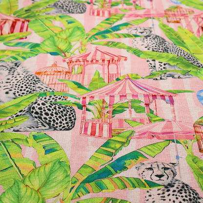 Pink striped fabric with a repeating pattern of seated cheetahs, tropical banana palm leaves, pink striped pavilions, birdcages, and blue porcelain ginger jars.   