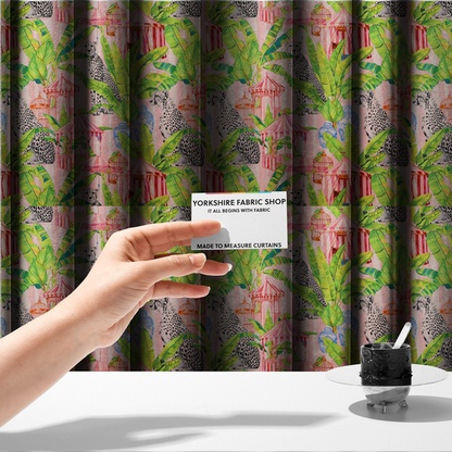The fabric used to create these made-to-measure curtains is a pink striped fabric with a repeating pattern of seated cheetahs, tropical banana palm leaves, pink striped pavilions, birdcages, and blue porcelain ginger jars.   