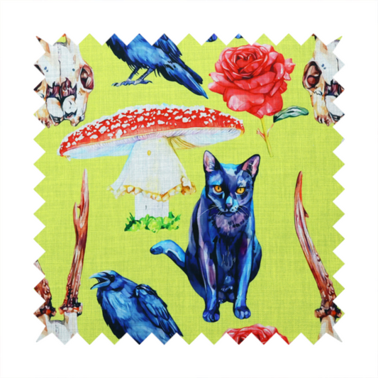 Chartreuse green fabric featuring a repeating pattern of black cats, blue ravens, red roses, horned animal skulls, and red fly agaric mushrooms.   