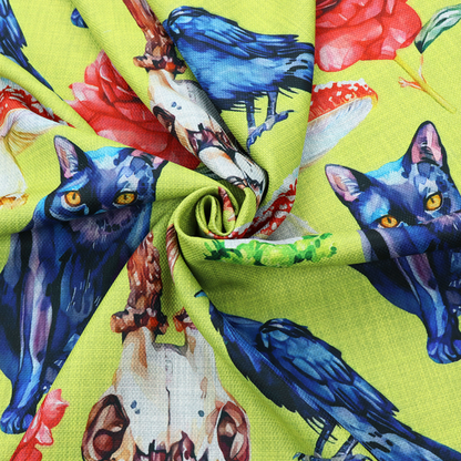 Chartreuse green fabric featuring a repeating pattern of black cats, blue ravens, red roses, horned animal skulls, and red fly agaric mushrooms.   