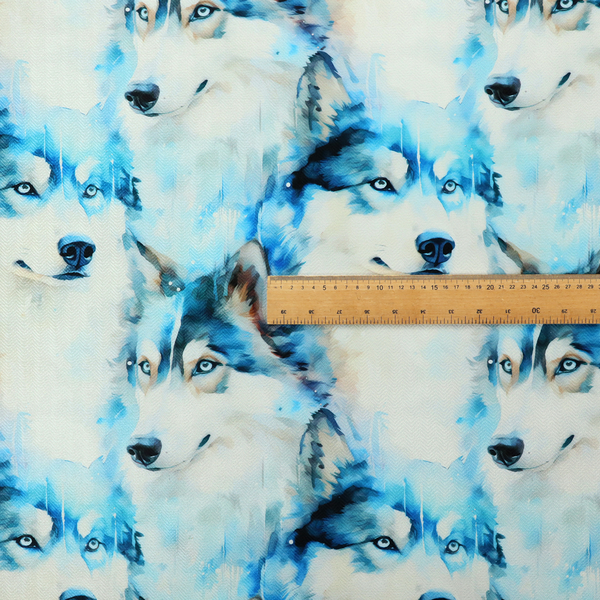Light fabric featuring a repeating watercolour pattern of husky or wolf portraits in shades of ice blue, teal, navy, and white.   