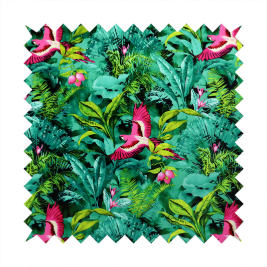 Tropical fabric featuring vibrant magenta parrots in flight surrounded by lush green palm fronds, banana leaves, and pink tropical flowers.   