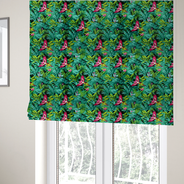 The fabric used to create these Roman blinds is a tropical fabric featuring vibrant magenta parrots in flight surrounded by lush green palm fronds, banana leaves, and pink tropical flowers.   