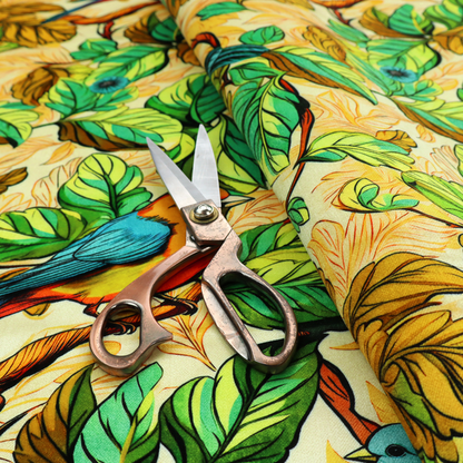Vibrant fabric featuring a repeating pattern of blue and orange songbirds perched among green, mustard yellow, and golden foliage on branches.