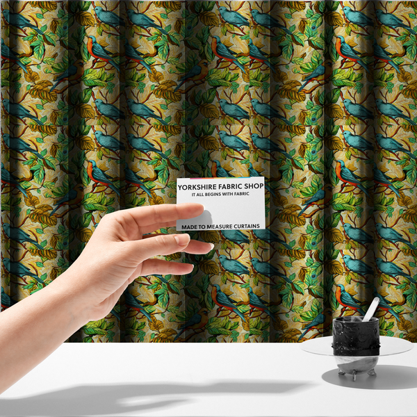 The fabric used to create these made-to-measure curtains is a vibrant fabric featuring a repeating pattern of blue and orange songbirds perched among green, mustard yellow, and golden foliage on branches.