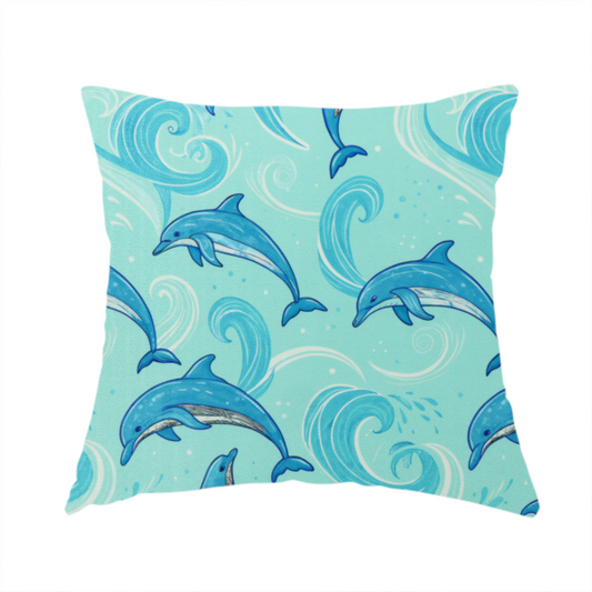 The fabric used to create this handmade cushion is an aqua blue fabric with a repeating pattern of playful blue dolphins leaping through swirling white ocean waves and water splashes.   