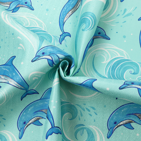 Aqua blue fabric with a repeating pattern of playful blue dolphins leaping through swirling white ocean waves and water splashes.   