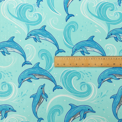 Aqua blue fabric with a repeating pattern of playful blue dolphins leaping through swirling white ocean waves and water splashes.   